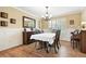 Formal dining room with wainscoting, chandelier lighting, and a view into the living spaces at 14194 W Amherst Ave, Lakewood, CO 80228
