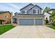 Charming two-story home with a three car garage, brick accents and well manicured front lawn at 14194 W Amherst Ave, Lakewood, CO 80228