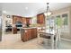 Spacious kitchen features a large island, stainless appliances, wood cabinetry, and eat-in kitchen area at 14194 W Amherst Ave, Lakewood, CO 80228
