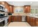 Traditional kitchen with stainless appliances, granite countertops, and custom wood cabinetry at 14194 W Amherst Ave, Lakewood, CO 80228