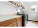 Bright laundry room with ample storage and counter space for folding at 14194 W Amherst Ave, Lakewood, CO 80228