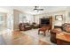 Comfortable living room with hardwood floors, a ceiling fan, and ample natural light at 14194 W Amherst Ave, Lakewood, CO 80228