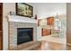 The living room, features a fireplace, and offers a view to the kitchen area at 14194 W Amherst Ave, Lakewood, CO 80228