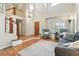Bright living room with vaulted ceilings, hardwood floors, and a large window with plantation shutters at 14194 W Amherst Ave, Lakewood, CO 80228