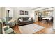 Comfortable living room with hardwood floors, neutral decor, and a view into the formal dining room at 14194 W Amherst Ave, Lakewood, CO 80228