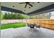 Relaxing covered patio with concrete pavers, ceiling fan, and view of fenced yard at 14194 W Amherst Ave, Lakewood, CO 80228