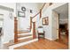 Elegant staircase with wooden steps, white risers, and a decorative chair adds charm at 14194 W Amherst Ave, Lakewood, CO 80228