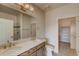 A full bathroom with dual sinks, a large mirror, and an open doorway to the linen closet at 881 W 128Th Pl, Westminster, CO 80234