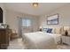 A styled bedroom featuring neutral walls, a large bed, decor, and a window at 881 W 128Th Pl, Westminster, CO 80234