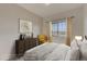 Comfortable bedroom featuring warm decor, natural light, and a view of the outdoors at 881 W 128Th Pl, Westminster, CO 80234