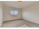 An empty bedroom space with neutral carpet and one large window letting in natural light at 881 W 128Th Pl, Westminster, CO 80234