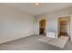 Empty bedroom showcasing neutral walls, carpet, and entryways to the bathroom and closet at 881 W 128Th Pl, Westminster, CO 80234
