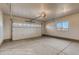 Spacious garage with overhead door, natural light from the window, and concrete flooring at 881 W 128Th Pl, Westminster, CO 80234