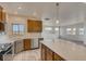 Kitchen featuring stainless steel appliances, a center island, and an open layout at 881 W 128Th Pl, Westminster, CO 80234