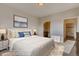 Calming main bedroom with a large bed, ensuite bathroom, and neutral decor at 881 W 128Th Pl, Westminster, CO 80234