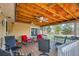 Covered back porch with ceiling fans, chairs, and view of the backyard at 273 S 13Th Ave, Brighton, CO 80601