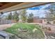 Beautiful backyard with grass, trees, and a fire pit for relaxing outdoors at 273 S 13Th Ave, Brighton, CO 80601