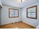 Hardwood floors and natural light highlight this simply designed bedroom with wooden window frames at 273 S 13Th Ave, Brighton, CO 80601
