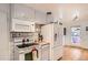 Functional kitchen featuring white appliances, tile backsplash, and ample counter space at 273 S 13Th Ave, Brighton, CO 80601