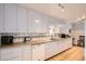Bright kitchen with white cabinets, tile countertops, and modern appliances at 273 S 13Th Ave, Brighton, CO 80601