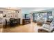 Open-concept living and dining area with hardwood floors and large windows at 273 S 13Th Ave, Brighton, CO 80601