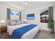 Comfortable bedroom with large windows, plush bedding, neutral tones, and modern decor at 17848 Gallup St, Broomfield, CO 80023