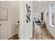 Bright hallway with hardwood floors leads to an open-concept living space at 17848 Gallup St, Broomfield, CO 80023