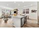 Bright, open kitchen with a large island, stainless steel dishwasher, and bar stool seating at 17848 Gallup St, Broomfield, CO 80023