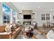 Bright living room featuring a fireplace and large windows, filled with natural light at 17848 Gallup St, Broomfield, CO 80023