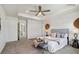 Spacious main bedroom with a tray ceiling, ensuite bathroom, and walk-in closet at 17848 Gallup St, Broomfield, CO 80023