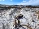 Aerial view showcases a mountain home nestled amidst snow-covered trees, emphasizing privacy at 97 Hedges Cir, Sedalia, CO 80135
