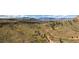 Wide overhead view of a mountain home nestled within an expansive landscape at 97 Hedges Cir, Sedalia, CO 80135