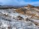 Expansive aerial view captures a snow-blanketed landscape, highlighting the home's seclusion amid mountain views at 97 Hedges Cir, Sedalia, CO 80135
