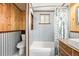 Functional bathroom featuring a tub, toilet, sink, and rustic decor elements, with wood and metal paneling at 97 Hedges Cir, Sedalia, CO 80135