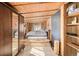 Unique bedroom design with raised platform, wooden walls, and large closet, offers style and functionality at 97 Hedges Cir, Sedalia, CO 80135