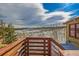 Deck with natural wood railing overlooking a winter landscape at 97 Hedges Cir, Sedalia, CO 80135