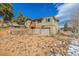 Two-story house features a two-car garage, a wooden staircase, and a stone wall accent at 97 Hedges Cir, Sedalia, CO 80135