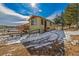 Charming exterior view of a home set in a serene, lightly snow-covered landscape at 97 Hedges Cir, Sedalia, CO 80135