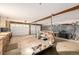 Open garage with storage shelves, work area, and space for multiple vehicles at 97 Hedges Cir, Sedalia, CO 80135