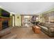 Spacious living room boasts fireplace, comfortable seating, and opens to the kitchen, perfect for entertaining at 97 Hedges Cir, Sedalia, CO 80135