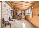 Wood-paneled office space with built-in shelves, desk, and a window overlooking a winter landscape at 97 Hedges Cir, Sedalia, CO 80135