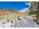 Exterior of a metal storage shed surrounded by a snow-covered landscape at 97 Hedges Cir, Sedalia, CO 80135