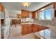 Bright kitchen features wood cabinets, granite counters, and a view to the living room at 13769 Omega Cir, Lone Tree, CO 80124