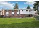 Backyard view of home featuring a lush lawn and mature trees at 3089 S Quintero Way, Aurora, CO 80013