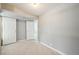 Finished basement featuring neutral paint, tile floors and two white paneled doors at 3089 S Quintero Way, Aurora, CO 80013