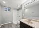 Renovated bathroom featuring new shower, vanity, lighting and plank flooring at 3089 S Quintero Way, Aurora, CO 80013