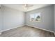 A clean bedroom with a window and modern grey flooring at 3089 S Quintero Way, Aurora, CO 80013