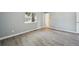 Bedroom with large window and new gray flooring at 3089 S Quintero Way, Aurora, CO 80013