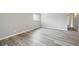 Bright bedroom with natural light, wood-look floors, and light gray walls at 3089 S Quintero Way, Aurora, CO 80013