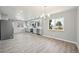 Kitchen area with gray cabinets, stainless appliances, and wood-look flooring at 3089 S Quintero Way, Aurora, CO 80013